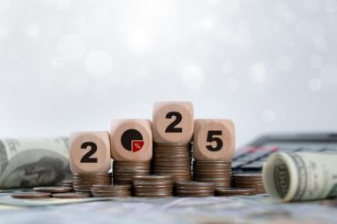 Tax 2025 wooden block on stack coin for income tax return.Tax, investment, financial, savings and New Year Resolution concepts. Business budget planning and investment growth in new year concept.