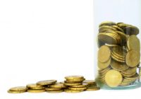coins piled up on table saving money no people on white background stock images stock photo