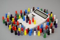 Many different figures of people  and calculator on gray background.