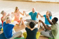 Group of mature friends laughing from funny stories after yoga