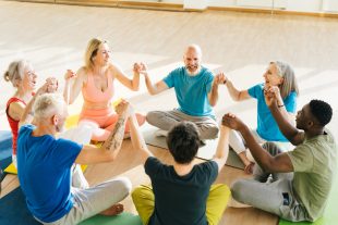 Group of mature friends laughing from funny stories after yoga