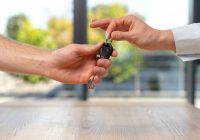Man taking key from young lady in formal wear shirt