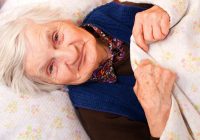Elderly lonely woman in the bed