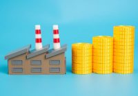 Industrial plant and growing stack of coins. Enterprise income. Payment of taxes. Industrial profitability and contribution to national budgets. Economic development. Tax from successful enterprises.