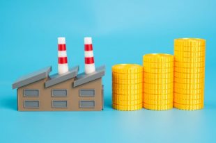 Industrial plant and growing stack of coins. Enterprise income. Payment of taxes. Industrial profitability and contribution to national budgets. Economic development. Tax from successful enterprises.