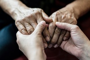 Parkinson and Alzheimer female senior elderly patient with careg