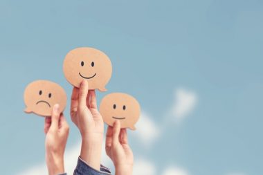 Customer showing rating with happy icon on sky background, Custo