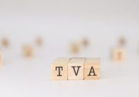 TVA acronym. Concept of Value Added Tax written on wooden cubes isolated on white background.