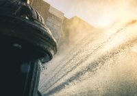 A Fire Hydrant spraying on people on a hot day in new york city