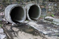 Two large concrete run-off pipes discharging water